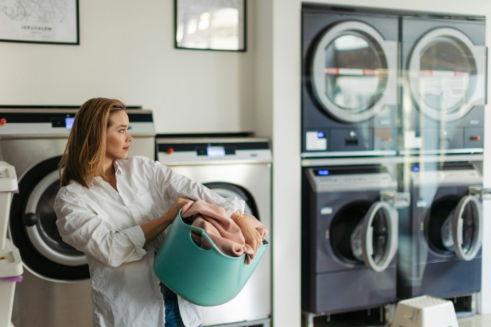 Young woman waiting in a laundry room.