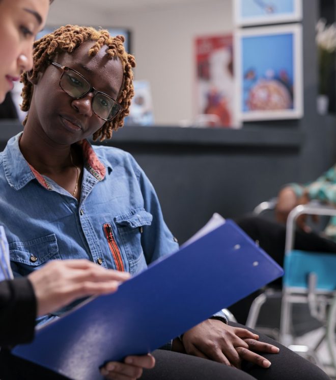 African american woman receiving instructions from physical therapist African american woman receiving instructions from physical therapist